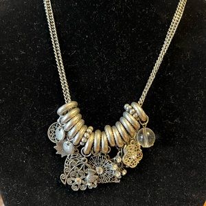 Vintage silver toned double strand metal necklace with many interesting charms